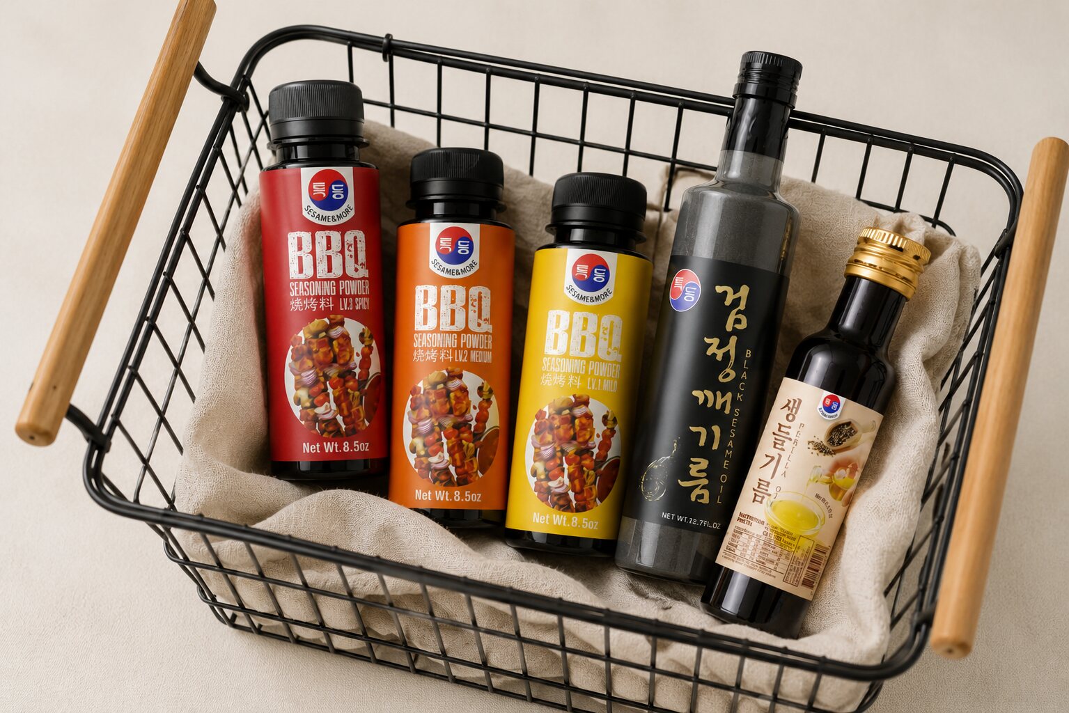 Packaging family in a wire shopping basket — BBQ sauces and oils reading as one brand